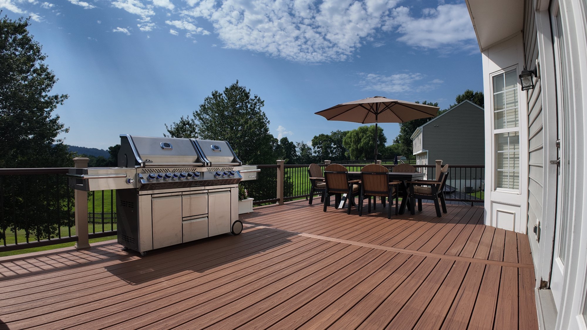 Composite deck with outdoor dining area built by Stoneridge in Fredericksburg, Virginia