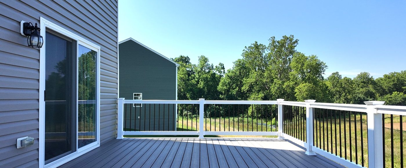 Composite deck with white railing and black balusters built by Stoneridge Decks in Virginia