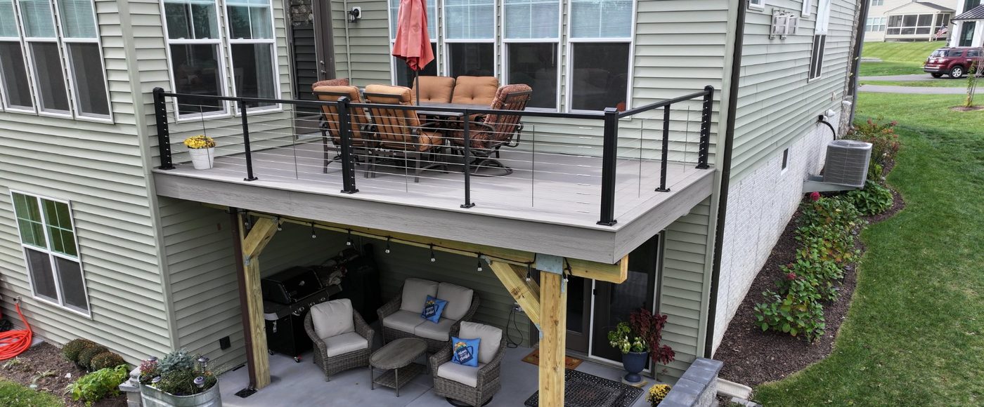 Stoneridge custom elevated deck with cable railing and outdoor living space below