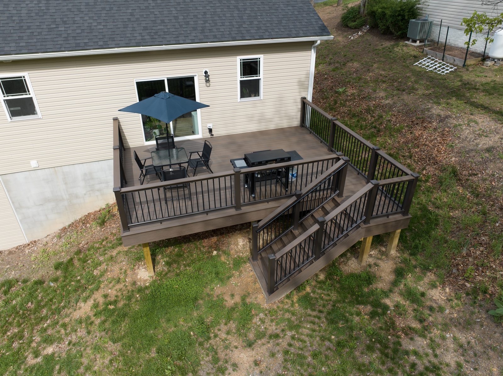 Elevated composite deck with stairs and aluminum railing built for the Bateman family by Stoneridge Decks for Vets in Winchester VA