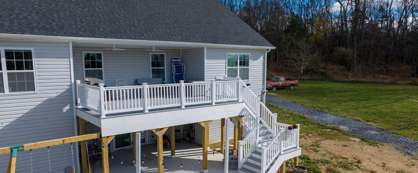 Stamped concrete patio with multilevel deck and screened porch by Stoneridge Decks in Virginia