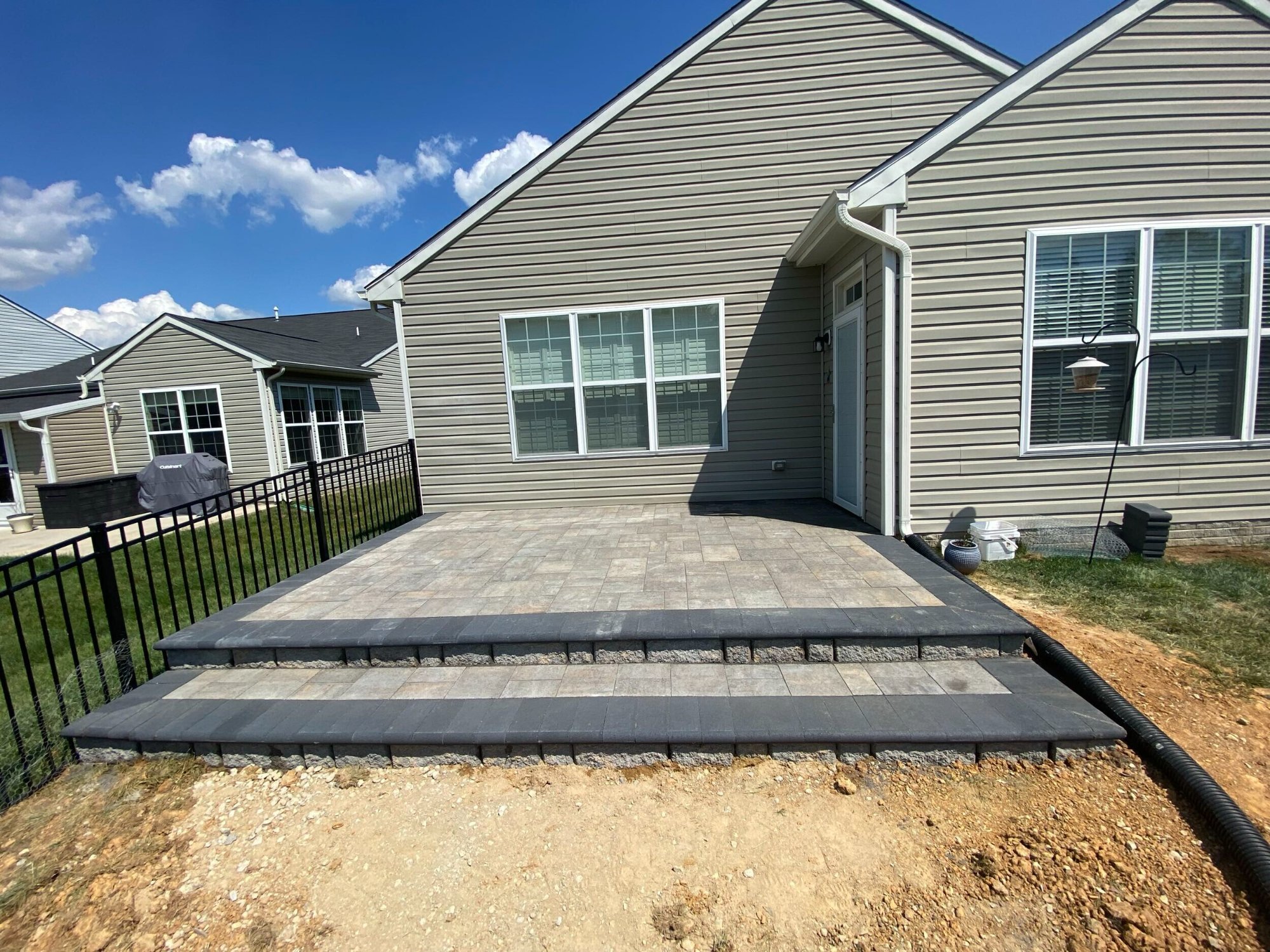 Raised paver patio with retaining wall