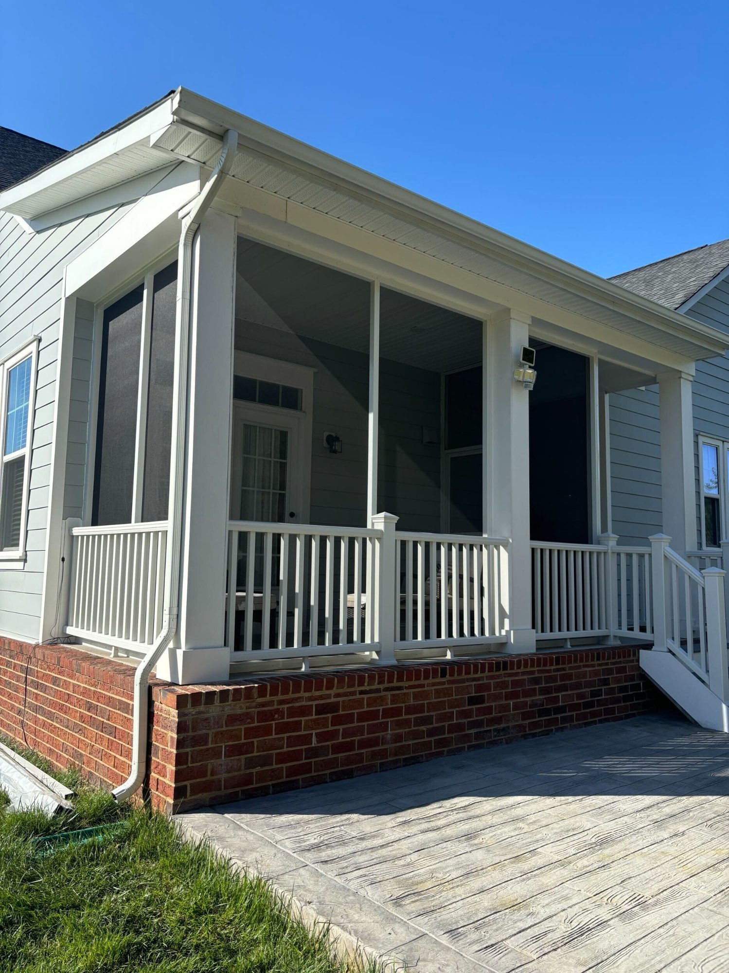 Screen porch with brick foundation built by Stoneridge Decks in Virginia