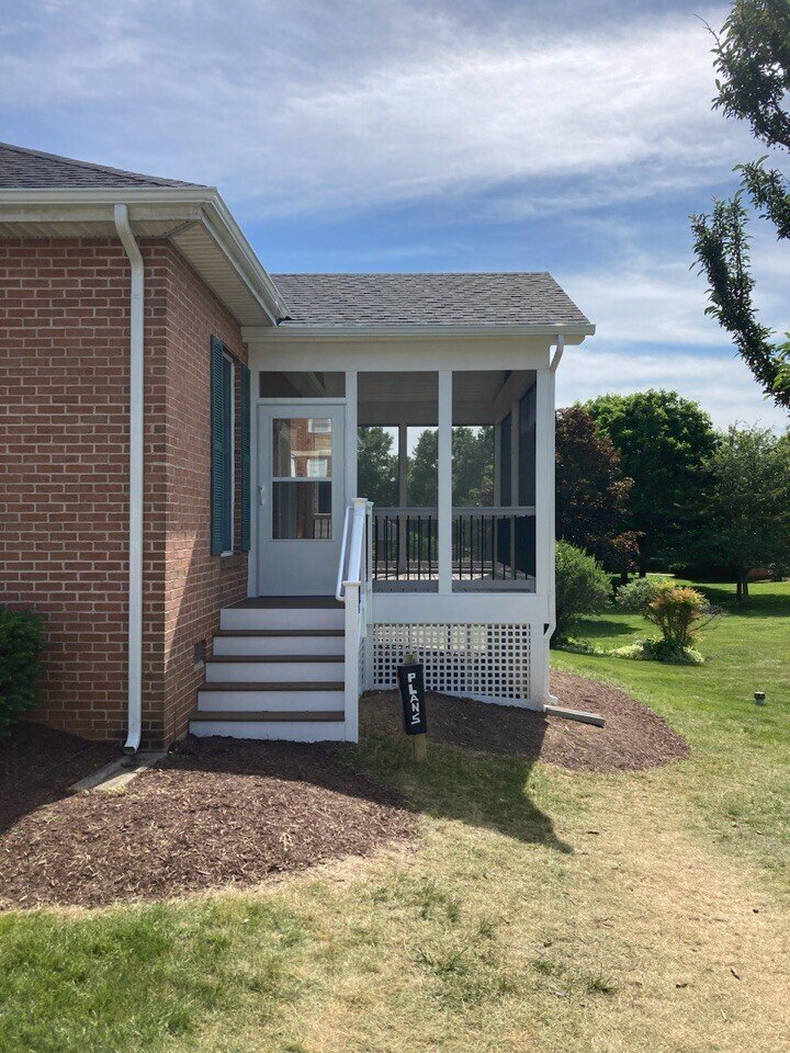 Small screen room exterior with brick built by Stoneridge Decks in Virginia